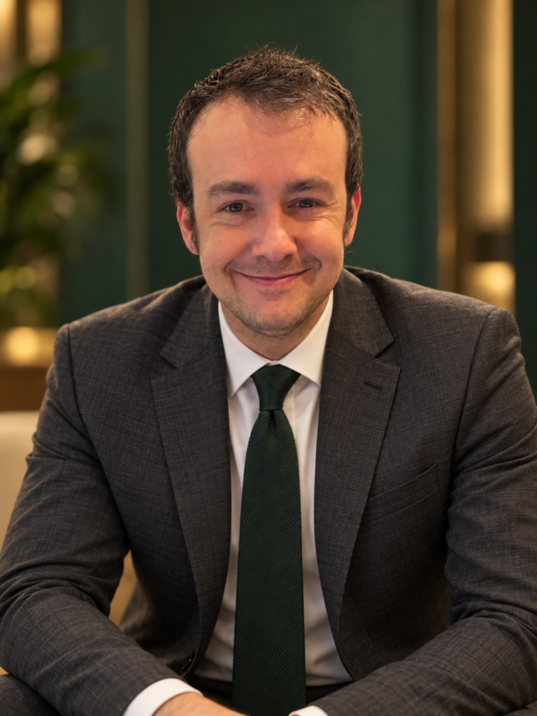 AI-created portrait of Brandon in a charcoal suit and green tie.